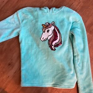 Blue fuzzy unicorn hooded sweater.